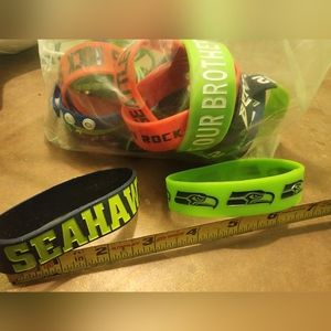 Lot of random Seattle Seahawks/Seattle radio stations wristbands
